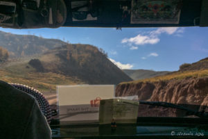 View through a UAZ windshield to the surrounding hills, Altai Mountains, Mongolia