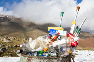 Rubbish bin full of food wrappers and empty bottles, cans and crutches, Altai Mountains Mongolia