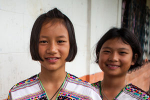 Portrait: Two Karen school children in traditional clothing, Mae Hong Son, Thailand.