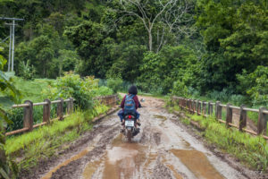 Girl on a Motorcycle on a muddy bridge, Mae Hong Son Thailand
