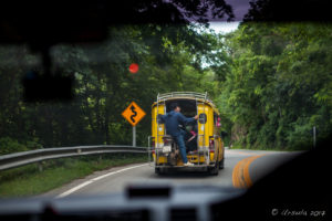 Thai man with a motorcycle Riding in the back of a SongTaew Bus, Mae Hong Son Thailand