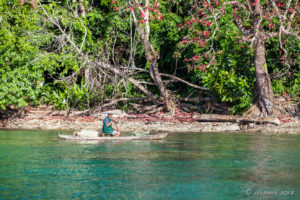 Elderly Papuan man in a canoe on Milne Bay, PNG