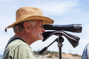 Profile portrait of a man with a spotting scope, Brickyard Community Park, Nanoose Bay BC Canada