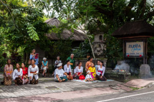 Balinese people seated at the side of a road, Ubud