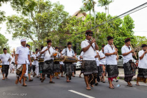 Balinese men in procession with musical instruments, Ubud