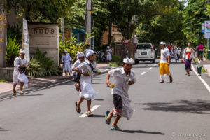 Balinese boys running in a roadway, Ubud