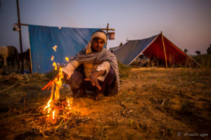 Indian man around a camp fire in the dark, Rajasthan