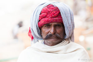Closeup of an Indian man in a red Turban, Pushkar Fair Grounds, Rajasthan