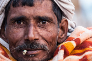 Closeup of an Indian man in an Orange Blanket, Pushkar Fair Grounds, Rajasthan
