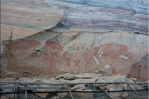 Pre-historic paintings of humans and elephants in red on Pha Taem Cliffs