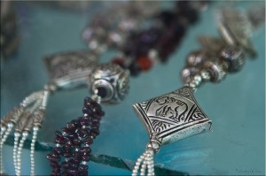 Close-up of silver pendants in Khmer Prakuem style