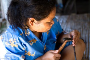Close-up of Thai woman beating silver with a small hammer