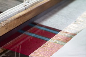 Unfinished weave of red, white and multi-coloured silk