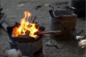 Metal drum with clay firepot and flames