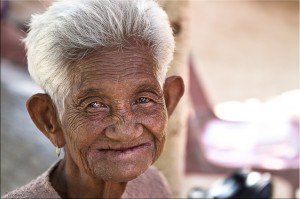 Portrait of a toothless elderly Thai woman with short white hair