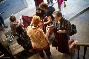 Women examining lengths of silk