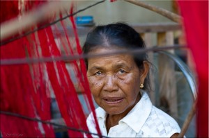 Elderly Thai woman Reeling red Silk