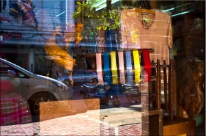 Glass window of a silk shop reflecting passing traffic