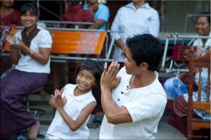 Man and young girl in traditional Thai dance: