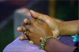 Close-up: folded hands in lap