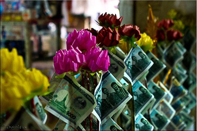 Lao money folded and placed on a stick with a bow