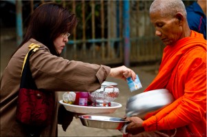 Woman giving alms