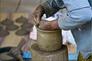 Hands making a clay pot