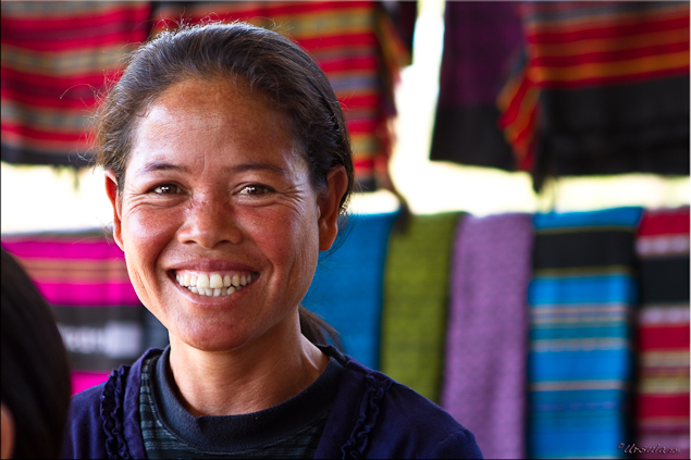 Portrait: Taliang woman and colourful cotton weaving (Laos)