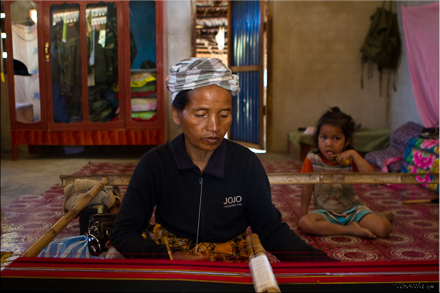 Lao Taliang woman reeling cotton.