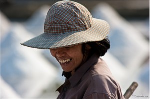 Portrait: Thai woman smiling; hidden by her hat