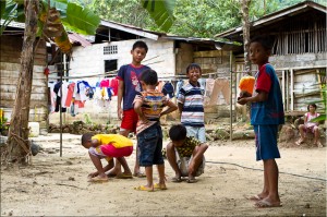 Children playing marbles on packed dirt