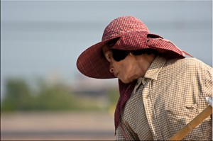Portrait: Older Thai woman in a red sunhat
