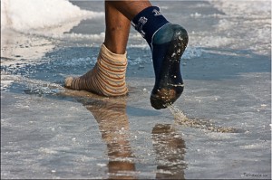 Close-up: feet in mis-matched wet socks