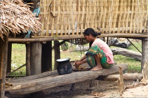 Lawae woman outdoors: preparing chicken for the pot