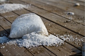 Broken bag of salt on wooden planks