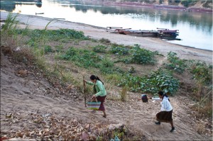 Two Lao Women walking up from the Xe Kong to Attapeu