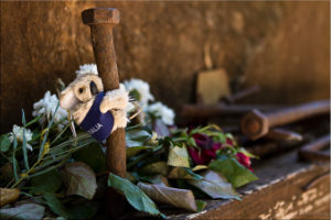 Small toy Koala clinging to a Rail Spike