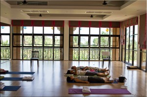 Three people in Savasana (corpse) posture