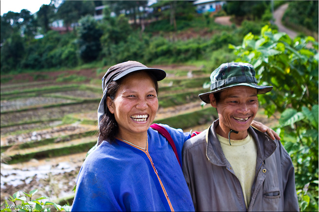 Karen man and woman in front of fields