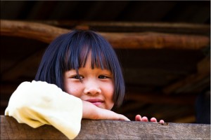 Karen girl looking over a wooden rail