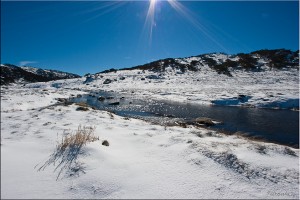 sun-flare over snow and water, Spencers Creek
