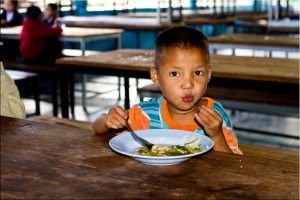 Young boy eating vegetable soup
