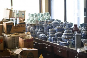 Storeroom: Foreground, blue and white pottery, Background, celadon buddhas