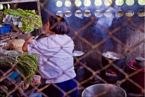 Thai girl in school uniform in a canteen kitchen