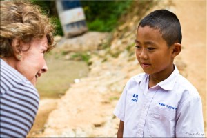 Woman talking to young Thai boy