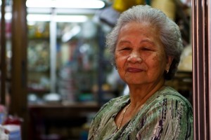 Elderly Chinese-Thai woman in shop doorway