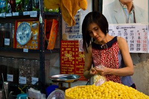 Woman in red bagging yellow loquat