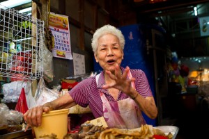 White haired lady sorting fried chicken wings