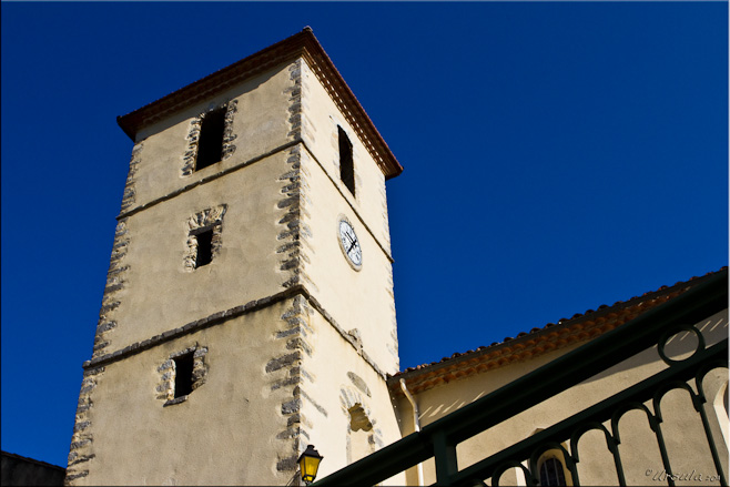 Modern church clock and bell tower against a blue sky