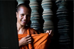 Portrait: Young monk fixing his saffron robes, Angkor Wat